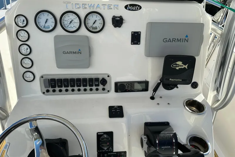 Slide: The Image of Control panel of a 2014 Tidewater 250 CC Adventure boat with Garmin and Raymarine equipment. - 15