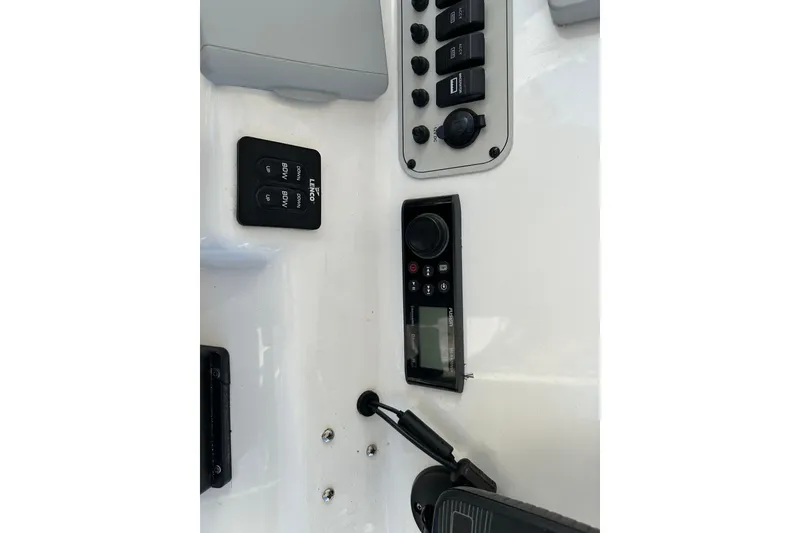 Slide: The Image of Control panel of a 2014 Tidewater 250 CC Adventure boat with various switches and dials. - 18