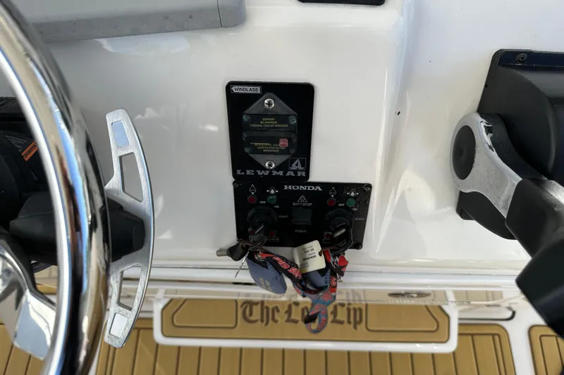 Slide: The Image of Control panel of a 2014 Tidewater 250 CC Adventure boat with Lewmar and Honda components. - 19