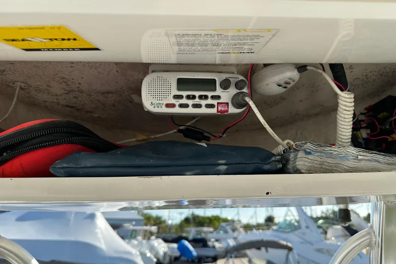 Slide: The Image of 2014 Tidewater 250 CC Adventure boat console with radio and storage items. - 20