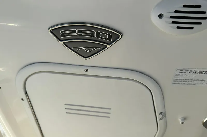 Slide: The Image of 2014 Tidewater 250 CC Adventure boat emblem and compliance label. - 22