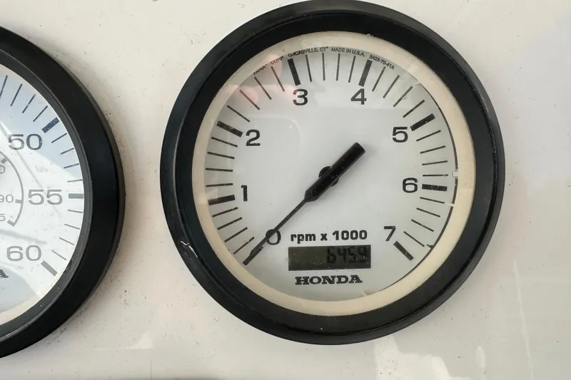 Slide: The Image of Honda tachometer displaying 6759 RPM on a 2014 Tidewater 250 CC Adventure boat. - 24