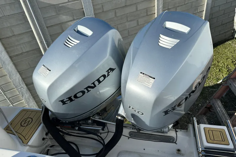 Slide: The Image of Twin Honda 150 outboard engines on a 2014 Tidewater 250 CC Adventure boat. - 31