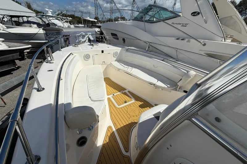 Slide: The Image of 2014 Tidewater 250 CC Adventure boat interior with white seating and teak flooring. - 32