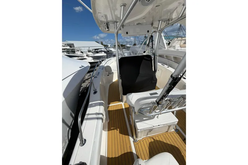 Slide: The Image of 2014 Tidewater 250 CC Adventure boat interior with seating and fishing rod holders. - 36