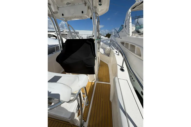 Slide: The Image of 2014 Tidewater 250 CC Adventure boat interior with teak flooring and seating. - 37