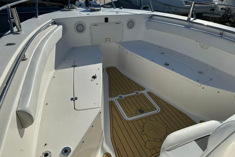 Slide: The Image of 2014 Tidewater 250 CC Adventure boat interior with cushioned seating and wood-patterned flooring. - 7