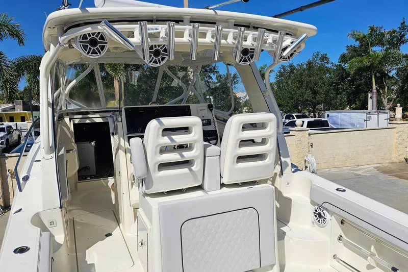 Slide: The Image of 2008 Hydra-Sports Vector 3500 VX boat interior with helm and seating, surrounded by palm trees. - 15