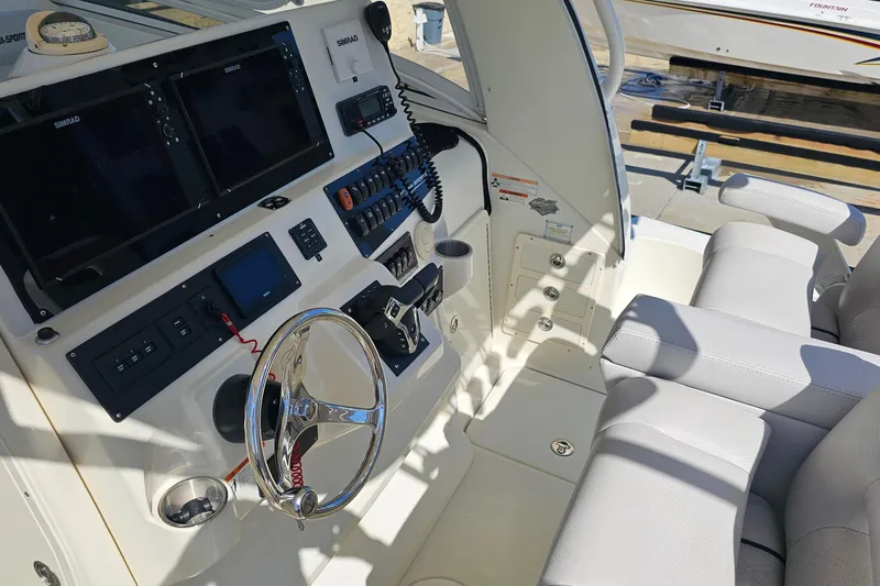 Slide: The Image of 2008 Hydra-Sports Vector 3500 VX boat cockpit with steering wheel and navigation controls. - 18
