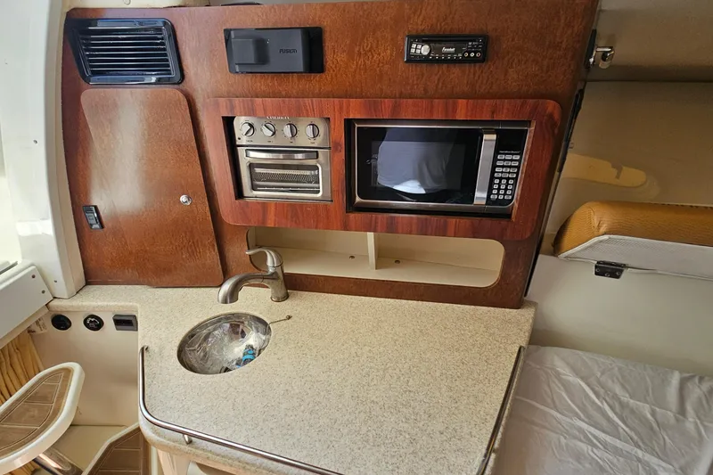 Slide: The Image of 2008 Hydra-Sports Vector 3500 VX cabin kitchen with sink, microwave, and wooden cabinetry. - 39