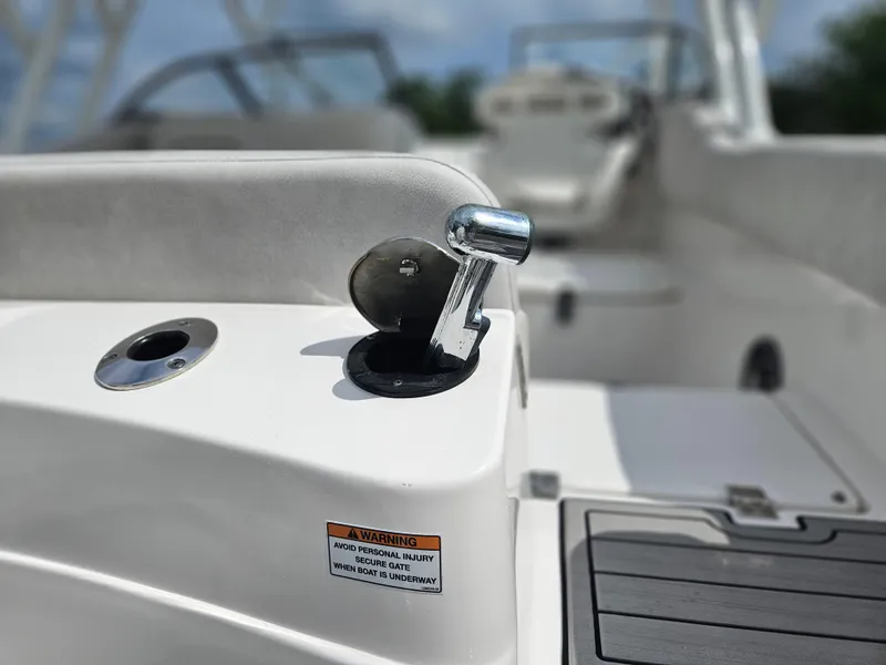 Slide: The Image of 2022 Sea Fox 226 Traveler boat interior with gray seating and white deck. - 16