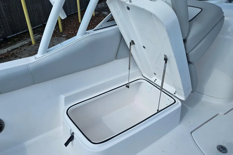 Slide: The Image of 2022 Sea Fox 226 Traveler boat interior with storage compartments and cooler. - 18