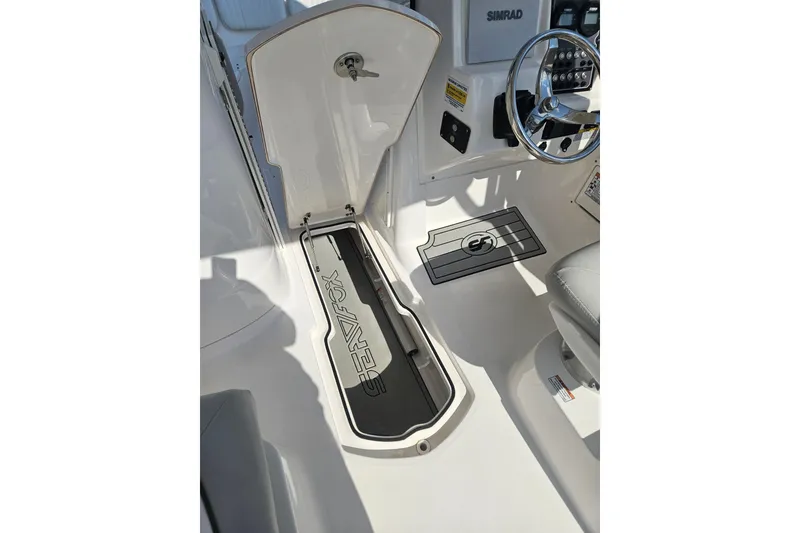 Slide: The Image of 2022 Sea Fox 226 Traveler boat interior with seating and table, featuring cup holders. - 29
