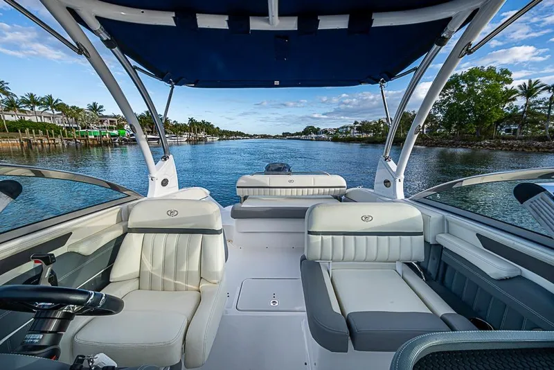 Slide: The Image of 2019 Cobalt 23SC boat interior with luxurious seating on a scenic waterway. - 11