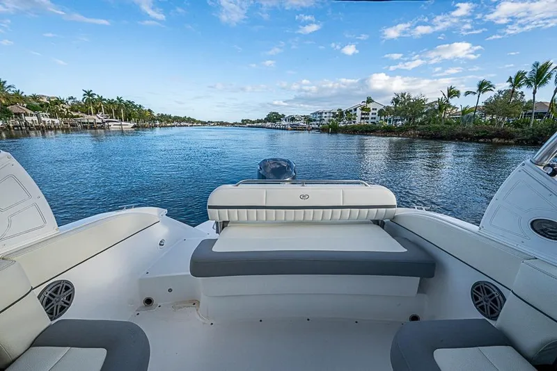Slide: The Image of 2019 Cobalt 23SC boat interior with scenic waterfront view and palm trees. - 15