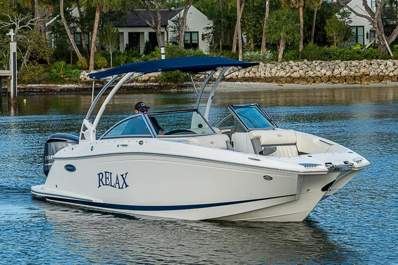 Slide: The Image of 2019 Cobalt 23SC boat on water with "RELAX" text, blue canopy, and scenic background. - 22