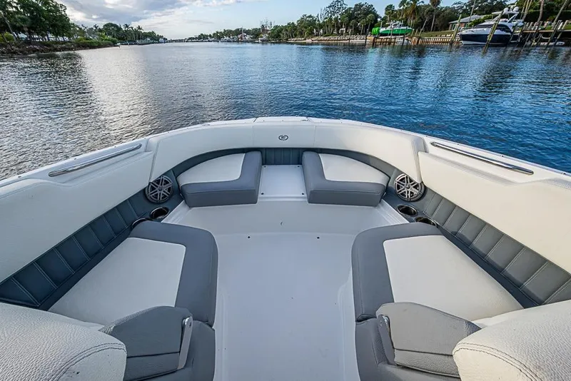 Slide: The Image of 2019 Cobalt 23SC boat interior with spacious seating on a serene waterway. - 5