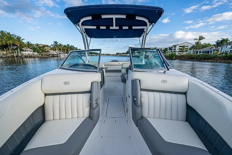 Slide: The Image of 2019 Cobalt 23SC boat interior with seating, on a scenic waterway. - 7