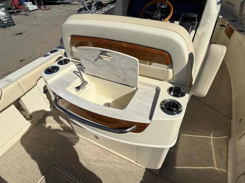 Slide: The Image of 2025 Chris-Craft Catalina 28 boat interior with sink and cup holders. - 11