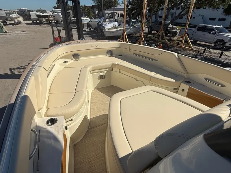 Slide: The Image of 2025 Chris-Craft Catalina 28 boat interior with beige seating and wood accents. - 14