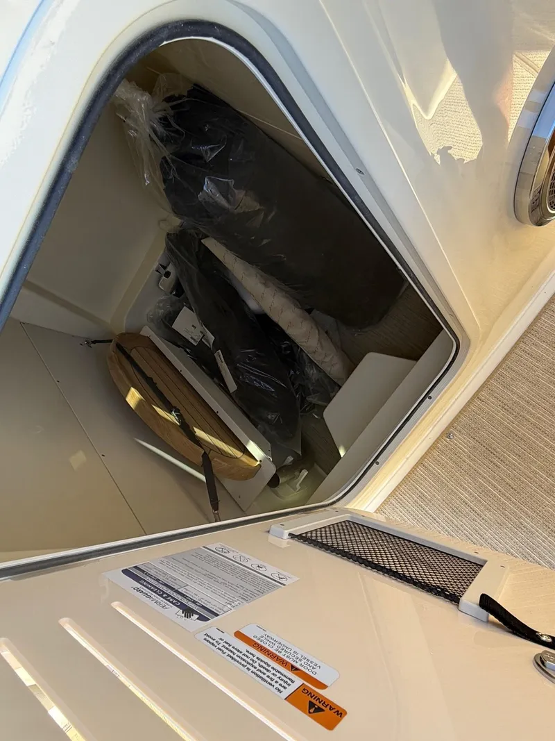 Slide: The Image of 2025 Chris-Craft Catalina 28 storage compartment with equipment and accessories. - 17
