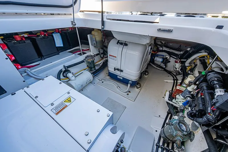 Slide: The Image of Engine compartment of 2023 Tiara Yachts 34 LS, showcasing batteries and mechanical components. - 20