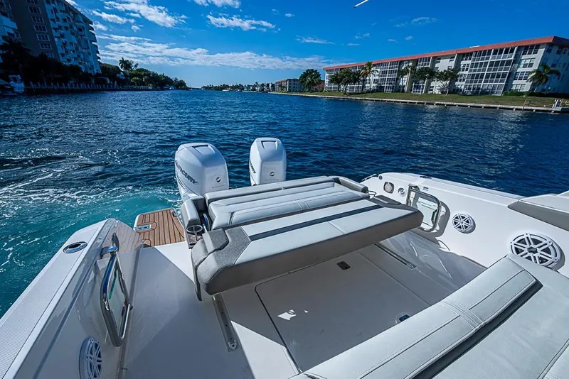 Slide: The Image of 2023 Tiara Yachts 34 LS on water, featuring luxurious seating and dual outboard engines. - 28