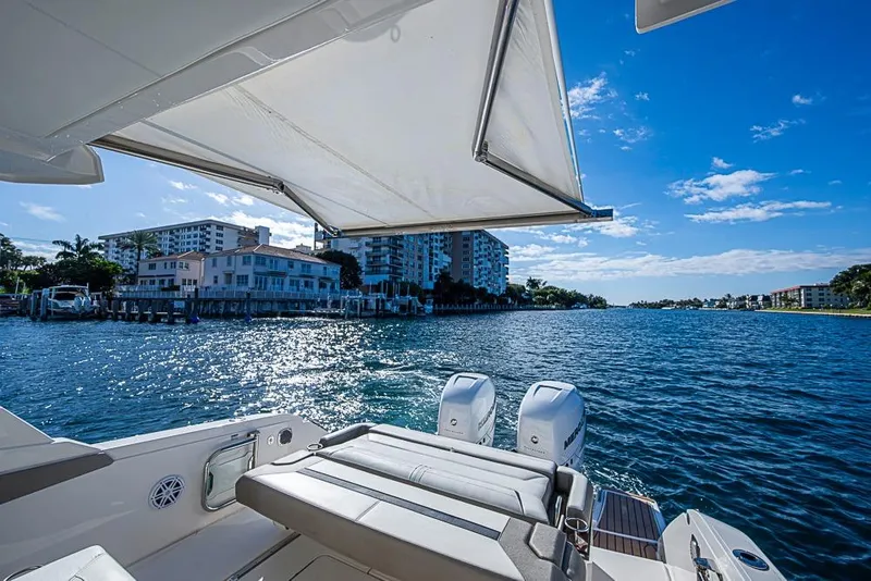 Slide: The Image of 2023 Tiara Yachts 34 LS on water, featuring spacious deck and scenic waterfront view. - 29