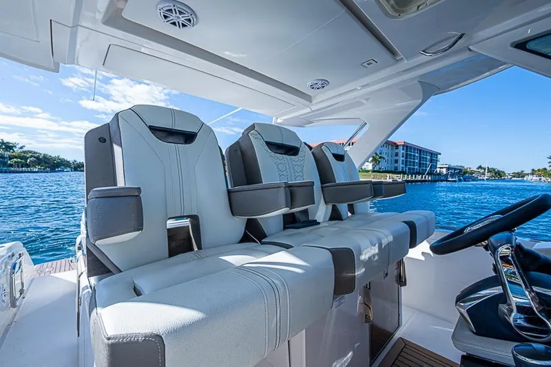 Slide: The Image of 2023 Tiara Yachts 34 LS interior with luxurious seating and scenic waterfront view. - 39