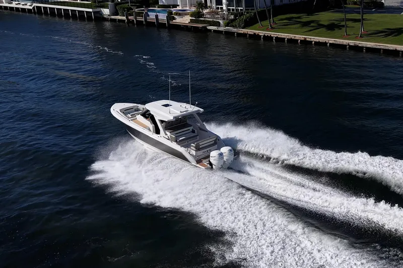 Slide: The Image of 2023 Tiara Yachts 34 LS cruising on water, creating dynamic wake. - 4