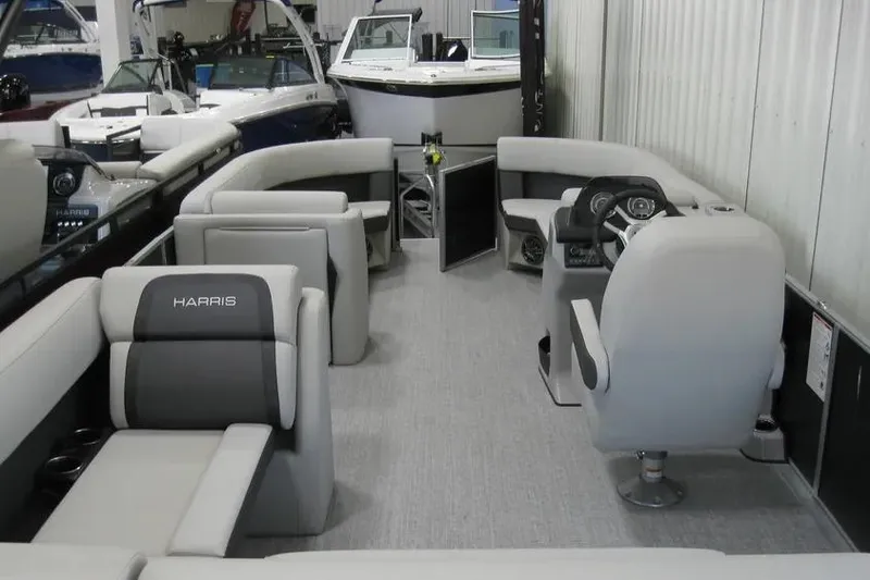 Slide: The Image of 2025 Harris FloteBote 230 Cruiser interior with plush seating and modern helm. - 10