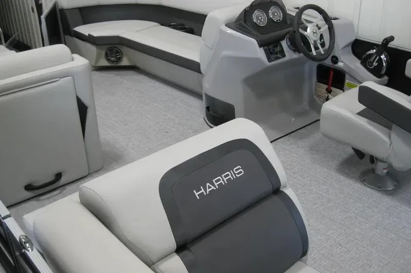 Slide: The Image of 2025 Harris FloteBote 230 Cruiser interior with modern seating and steering console. - 11