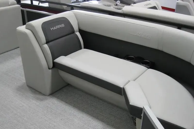 Slide: The Image of 2025 Harris FloteBote 230 Cruiser interior seating with cup holders, featuring sleek gray upholstery. - 4