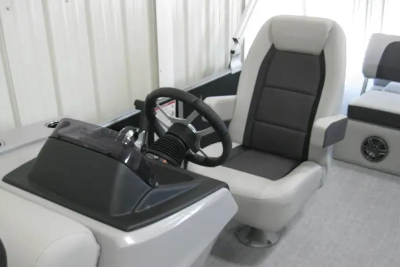 Slide: The Image of 2025 Harris FloteBote 230 Cruiser interior with steering wheel and captain's chair. - 5