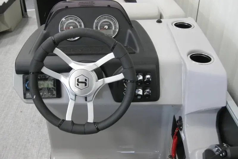 Slide: The Image of Steering console of 2025 Harris FloteBote 230 Cruiser with modern controls and gauges. - 6