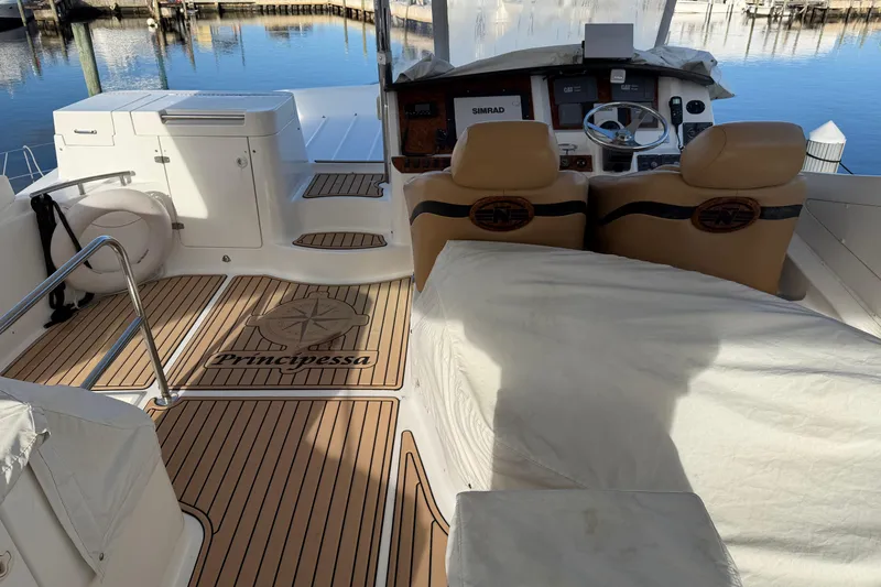 Slide: The Image of 2006 Neptunus 56 Flybridge yacht interior with helm, seating, and "Principessa" deck design. - 10