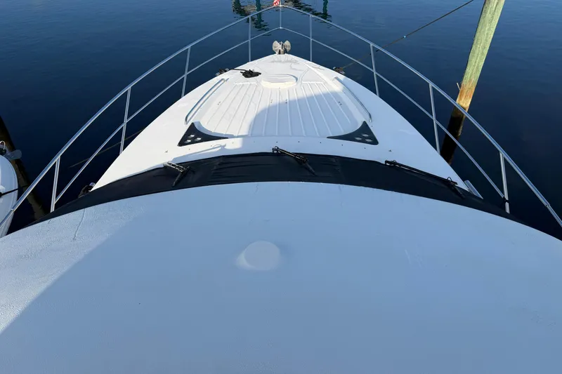 Slide: The Image of Bow view of 2006 Neptunus 56 Flybridge yacht docked on calm water. - 12