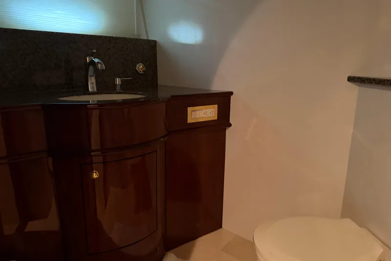 Slide: The Image of Luxurious bathroom in 2006 Neptunus 56 Flybridge yacht with elegant wood cabinetry. - 26