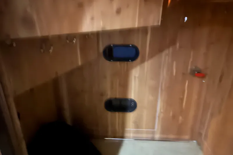 Slide: The Image of Interior of 2006 Neptunus 56 Flybridge yacht with wooden paneling and portholes. - 28