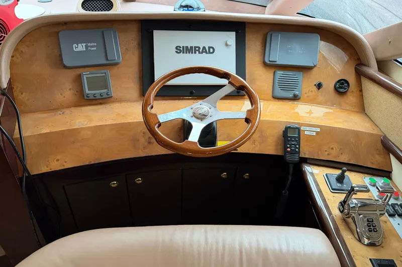 Slide: The Image of Helm of 2006 Neptunus 56 Flybridge yacht with Simrad navigation and CAT Marine Power controls. - 44