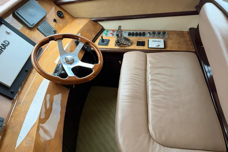 Slide: The Image of Helm of 2006 Neptunus 56 Flybridge yacht with wooden steering wheel and controls. - 45