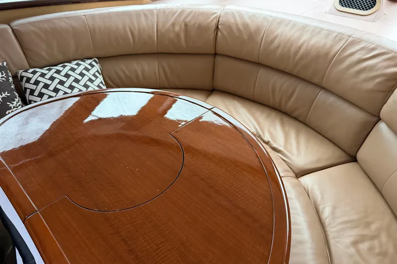 Slide: The Image of Luxurious leather seating and wooden table on 2006 Neptunus 56 Flybridge yacht interior. - 47