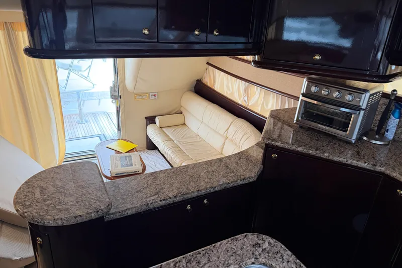 Slide: The Image of Luxurious interior of 2006 Neptunus 56 Flybridge yacht with granite countertops and cozy seating. - 49