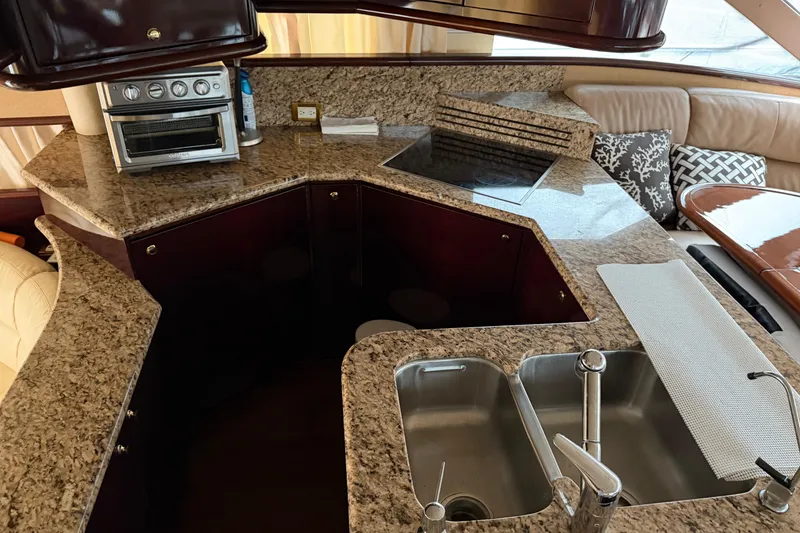 Slide: The Image of Luxurious kitchen area in 2006 Neptunus 56 Flybridge yacht with granite countertops and modern appliances. - 52