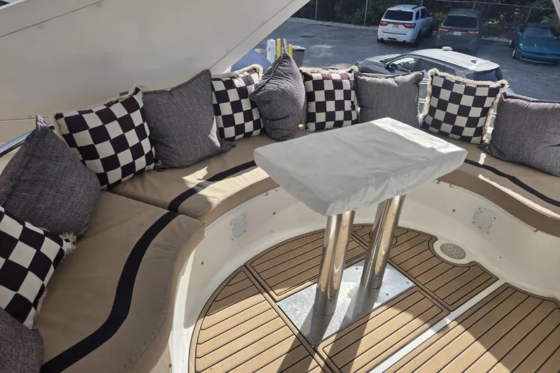 Slide: The Image of Luxurious seating area on 2006 Neptunus 56 Flybridge with checkered cushions and sleek table. - 61