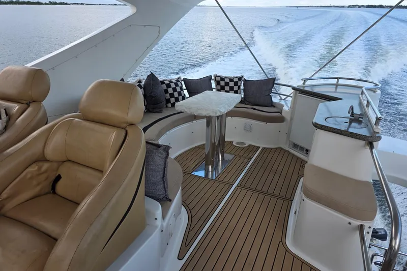 Slide: The Image of Luxurious 2006 Neptunus 56 Flybridge yacht interior with plush seating and ocean view. - 62