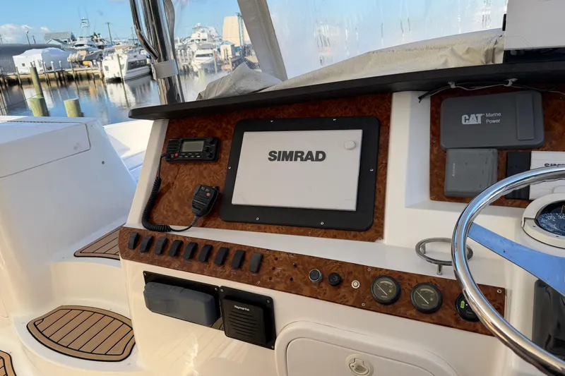 Slide: The Image of 2006 Neptunus 56 Flybridge helm with Simrad navigation and CAT Marine Power controls. - 7