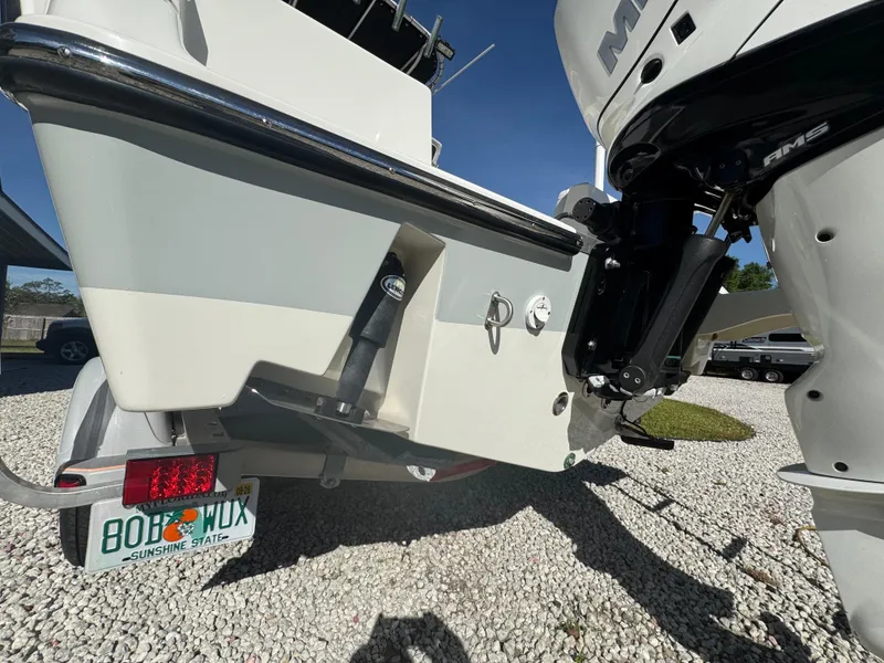 Slide: The Image of 2019 Mako 214C boat rear view with motor and Florida license plate. - 12