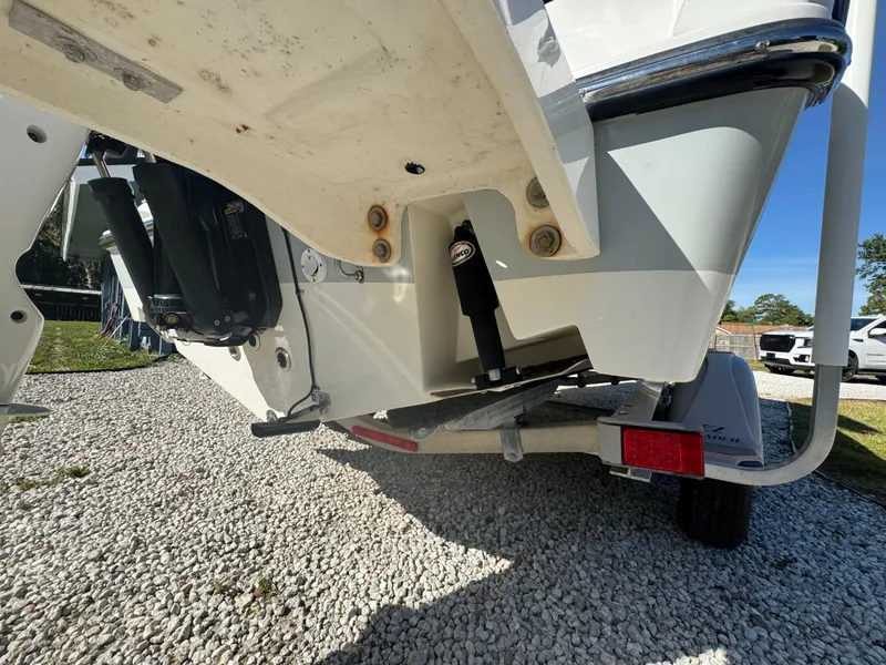 Slide: The Image of Rear view of a 2019 Mako 214C boat on a trailer, showing the hull and motor. - 16