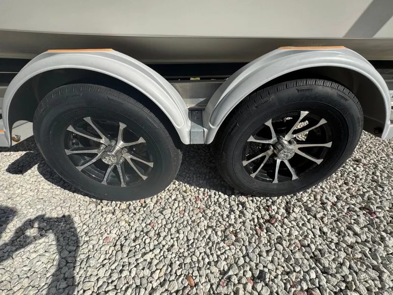 Slide: The Image of Dual wheels of a 2019 Mako 214C trailer on gravel surface. - 24